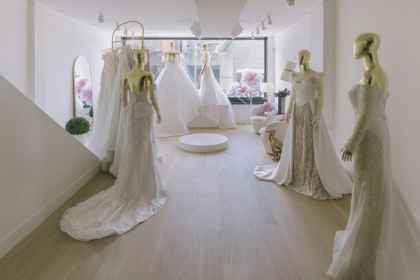 Mannequins display elegant wedding dresses inside a bridal boutique.